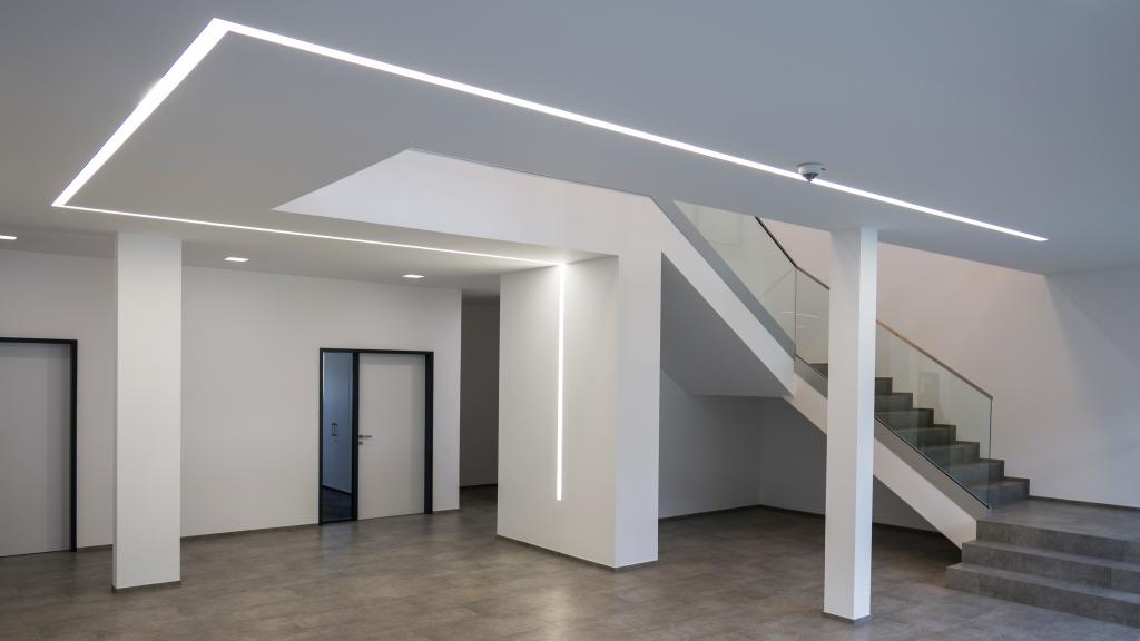 Entrance area with modern strip lighting in Optirent's modular administration building