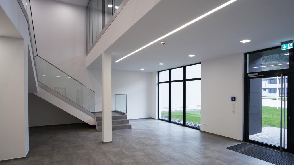 Bright entrance area of the modular Optirent administration building 