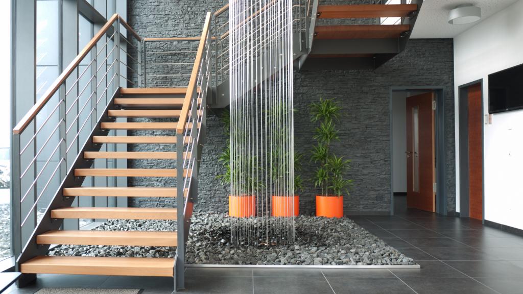 Modern entrance area with staircase at Evertz Hydrotechnik in Betzdorf